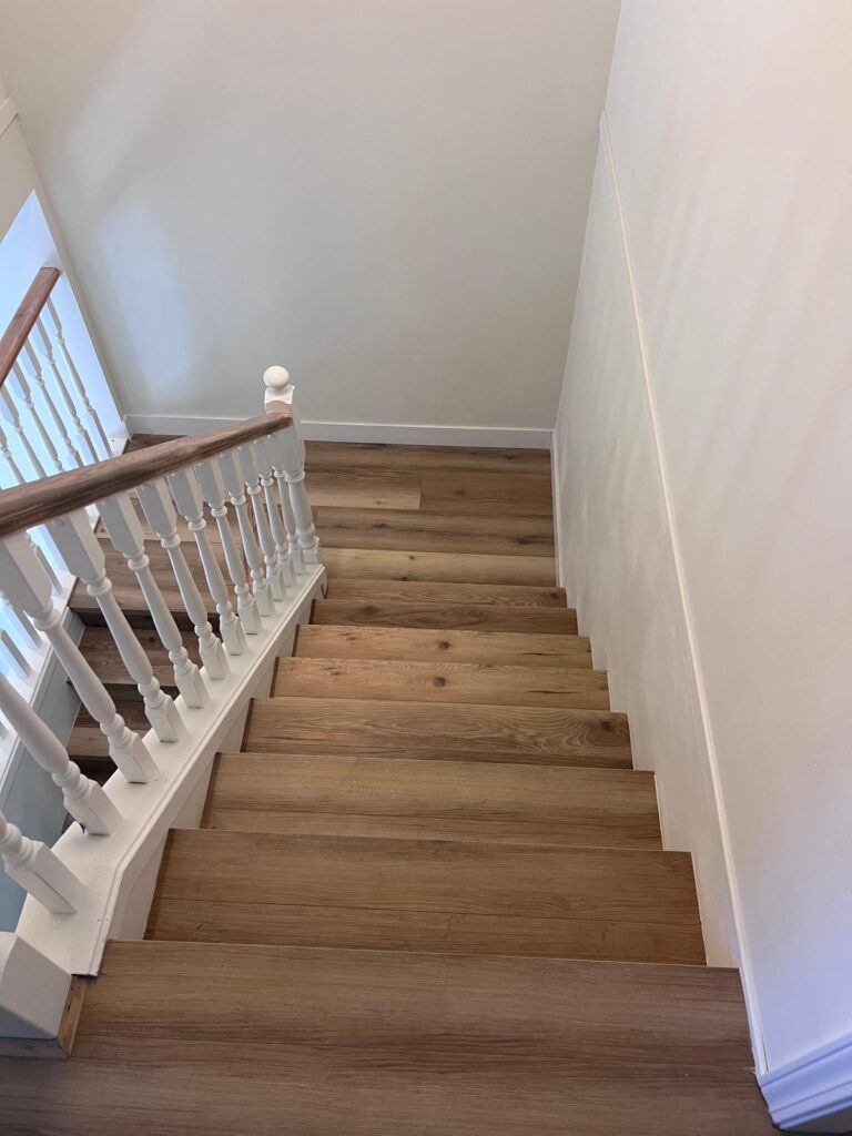 Step by Step Home Renovation Process in Vancouver BC 2 Interior staircase and hallway renovation in West Vancouver featuring new flooring railings and clean finishes